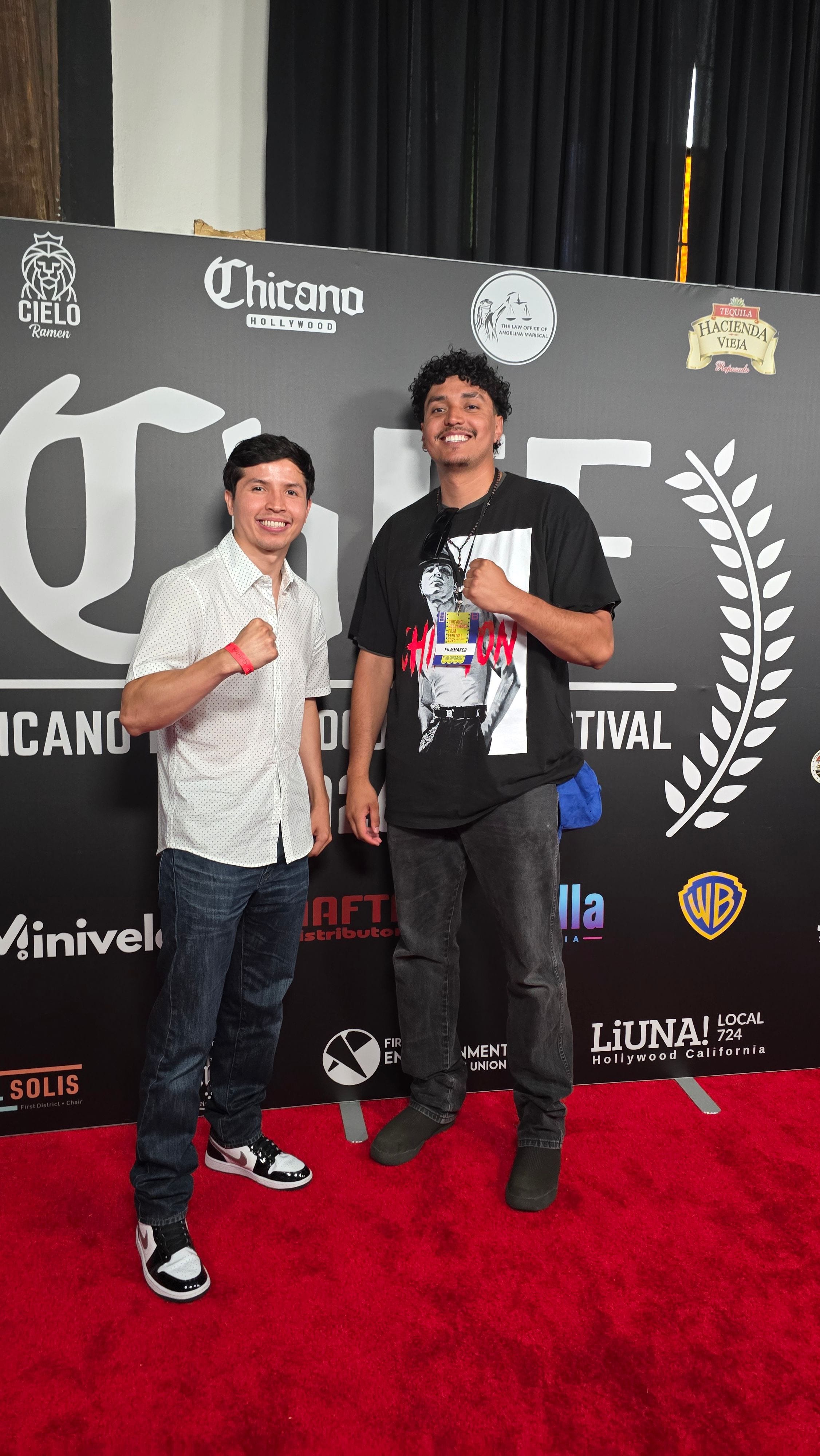 José Alfredo Alvarez posing with filmmakers on a film festival red carpet.